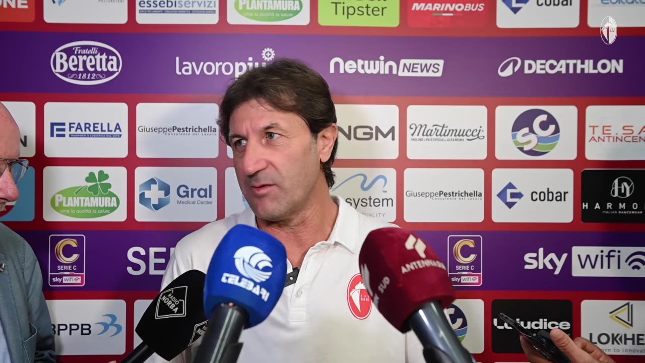 Allenatore guarda di lato mentre parla